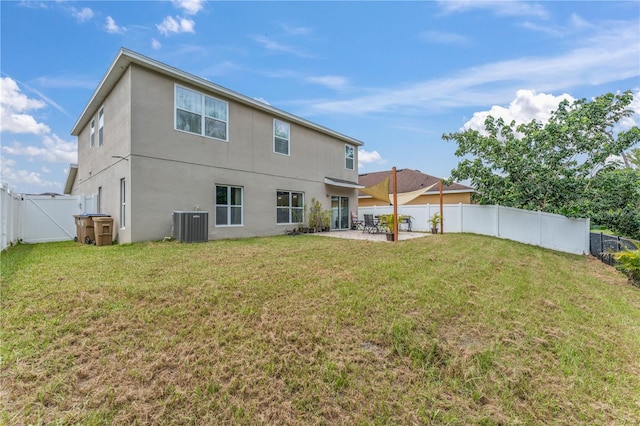 back of property featuring a patio area, cooling unit, and a lawn