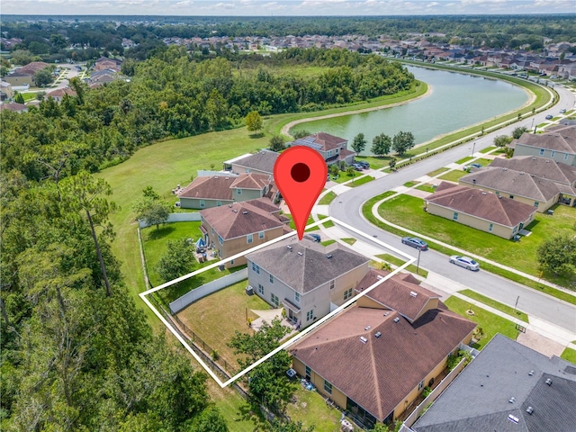 birds eye view of property with a water view