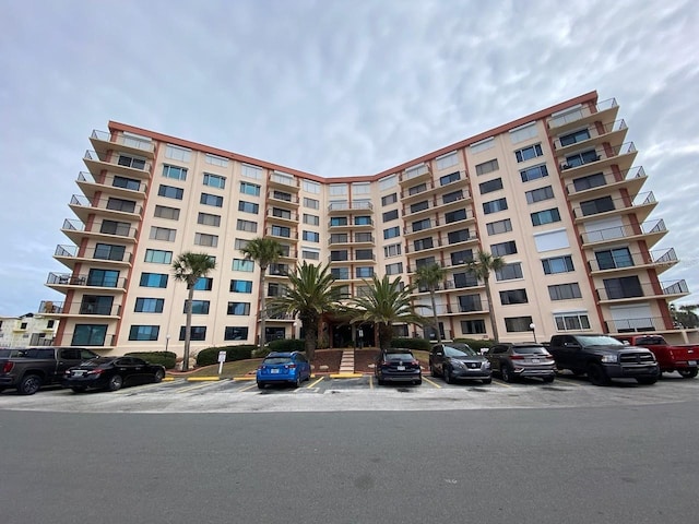 view of building exterior featuring uncovered parking