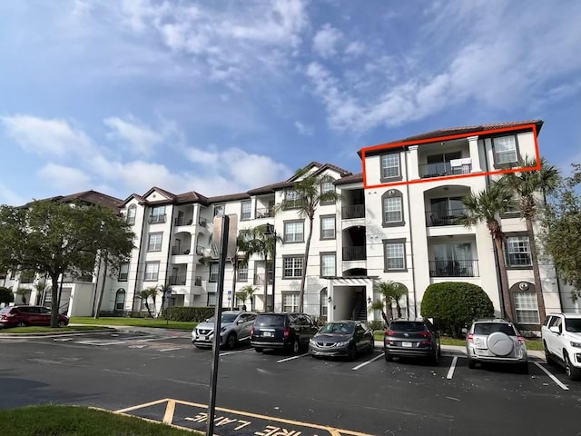 view of property featuring uncovered parking