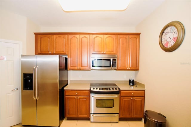 kitchen featuring light tile patterned floors and appliances with stainless steel finishes