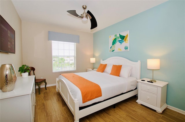 bedroom with hardwood / wood-style flooring and ceiling fan