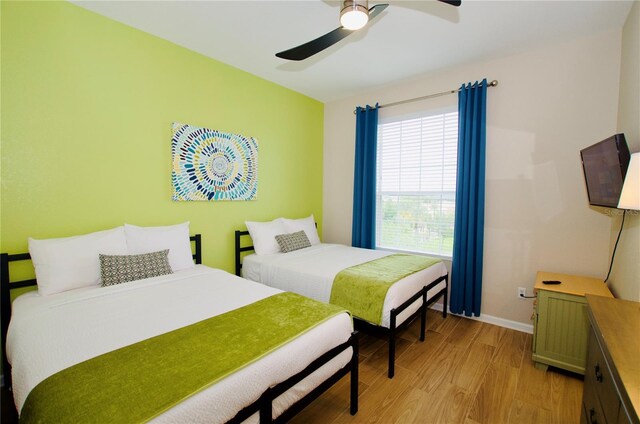 bedroom with ceiling fan and light hardwood / wood-style floors