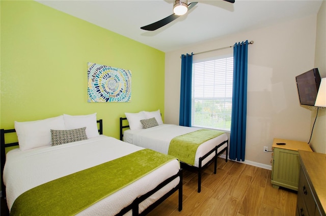 4114 Breakview Dr Unit 406, Orlando, FL 32819 - bedroom featuring baseboards, ceiling fan, and light wood finished floors