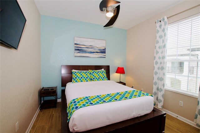4114 Breakview Dr Unit 406, Orlando, FL 32819 - bedroom with multiple windows, wood finished floors, and baseboards