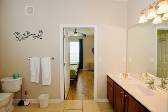 bathroom featuring hardwood / wood-style flooring, ceiling fan, toilet, and vanity