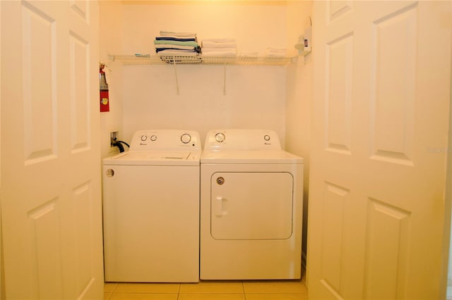 washroom with washer and dryer and light tile patterned floors