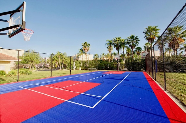 view of basketball court with a yard