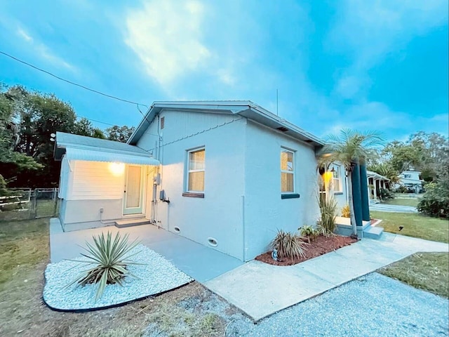 view of property exterior with a patio