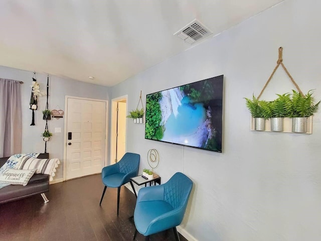 living area with hardwood / wood-style flooring