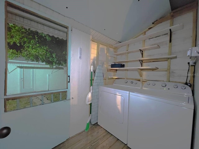 clothes washing area featuring independent washer and dryer and light hardwood / wood-style flooring