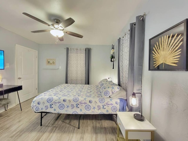 bedroom with ceiling fan and light wood-type flooring