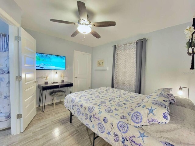 bedroom with light hardwood / wood-style floors and ceiling fan