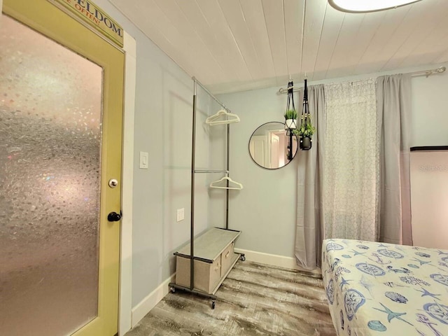 bathroom featuring hardwood / wood-style flooring, a shower, and wooden ceiling