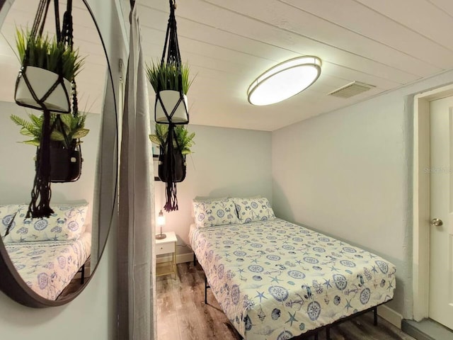 bedroom with dark wood-type flooring