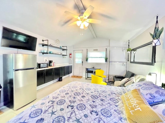 bedroom with lofted ceiling with beams, light tile patterned floors, and stainless steel refrigerator