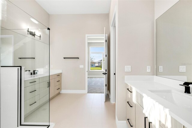 815 Liliana Dr, Deland, FL 32724 - bathroom with two vanities, a stall shower, baseboards, and tile patterned flooring