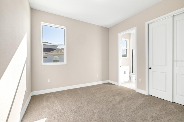 815 Liliana Dr, Deland, FL 32724 - unfurnished bedroom featuring carpet, ensuite bath, baseboards, and a closet
