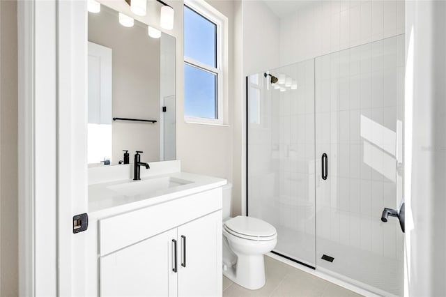 bathroom with toilet, a shower with shower door, vanity, and tile patterned floors