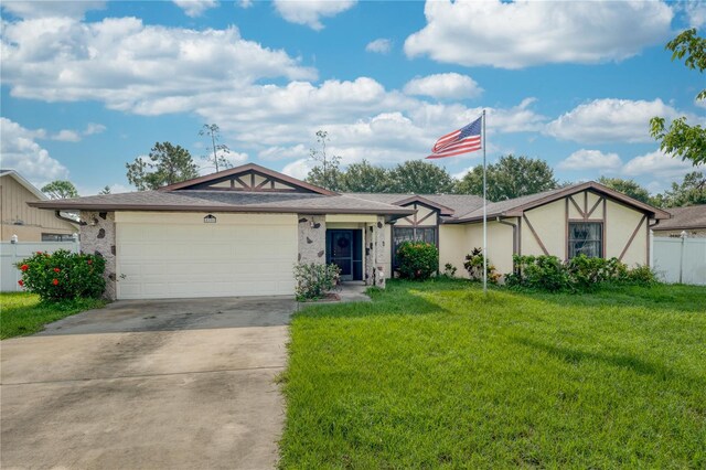 view of front of property with a front yard and a garage