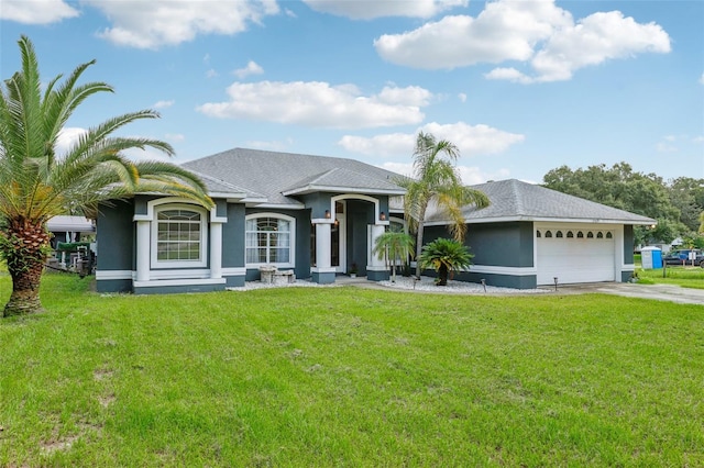 view of front of house with a garage and a front yard