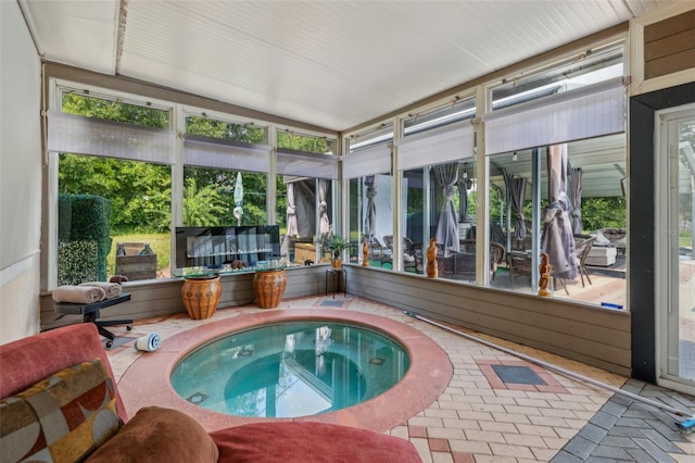 sunroom featuring a jacuzzi