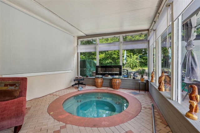 sunroom with a jacuzzi