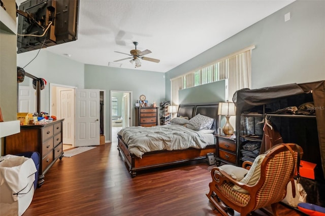 bedroom featuring ceiling fan, dark hardwood / wood-style floors, and ensuite bathroom