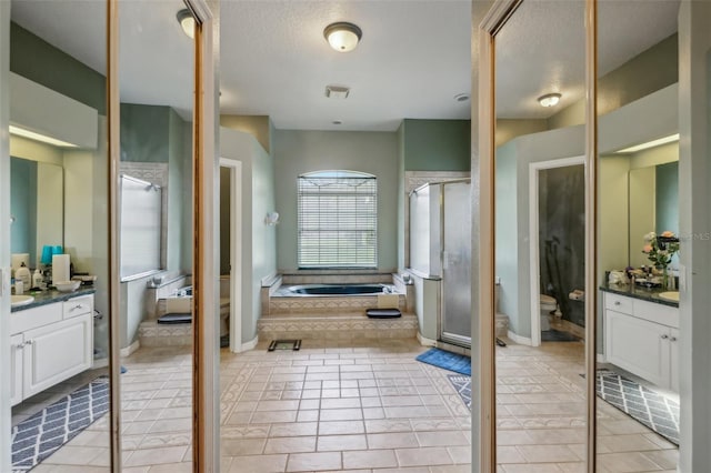 full bathroom featuring tile patterned flooring, toilet, plus walk in shower, and vanity