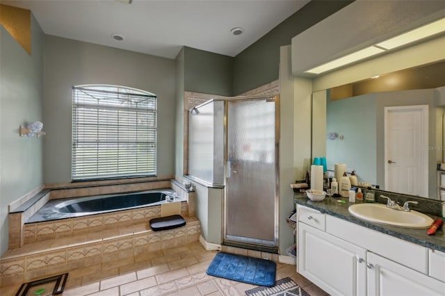 bathroom featuring tile patterned floors, plus walk in shower, and vanity