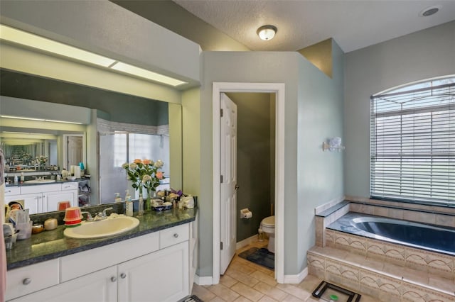 bathroom with toilet, a relaxing tiled tub, tile patterned flooring, and vanity