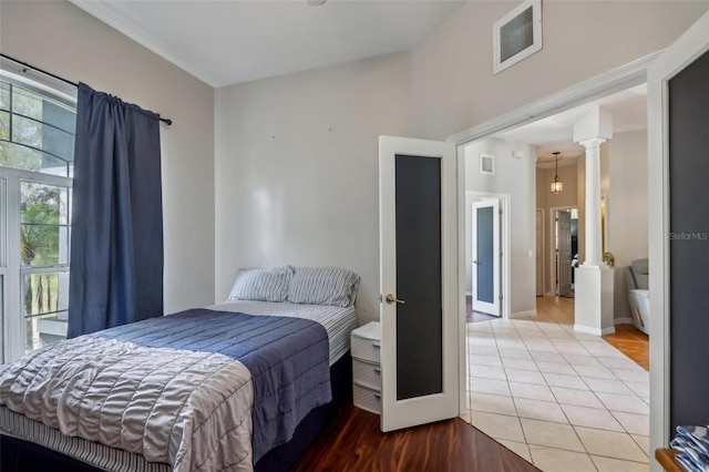 tiled bedroom featuring ornate columns