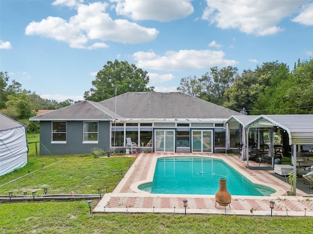 view of pool with a patio area and a yard