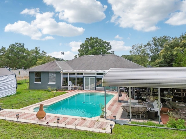 view of swimming pool with a patio area and a yard