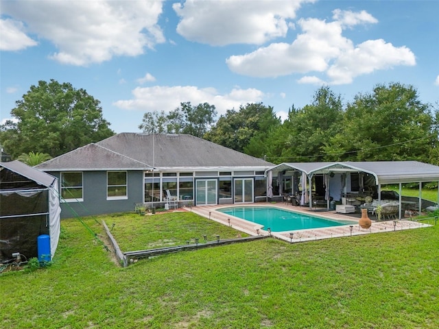 back of house featuring a patio and a yard