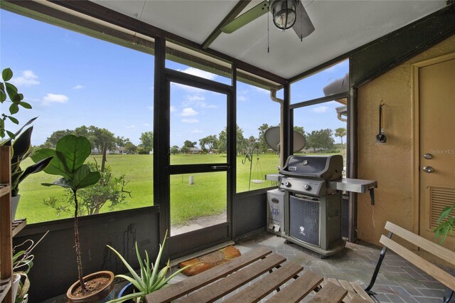 sunroom / solarium featuring ceiling fan