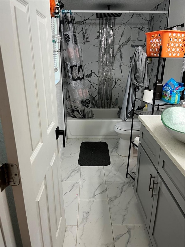 full bath with marble finish floor, vanity, toilet, and shower / bath combo with shower curtain