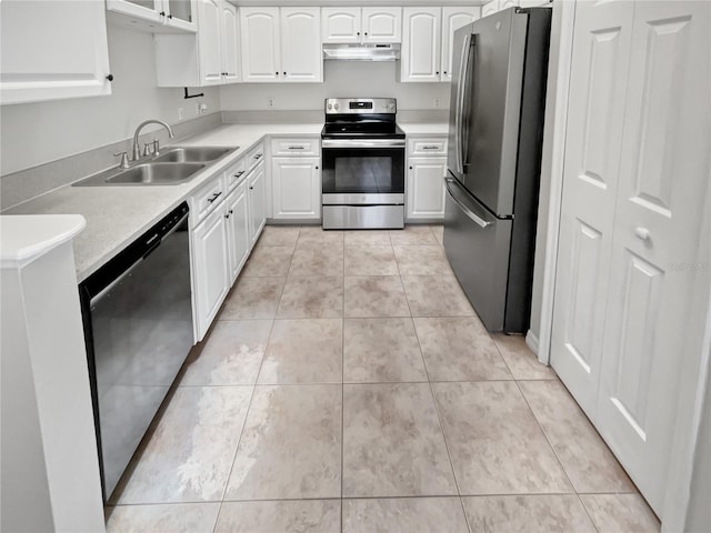 kitchen with light tile patterned flooring, sink, appliances with stainless steel finishes, and white cabinets