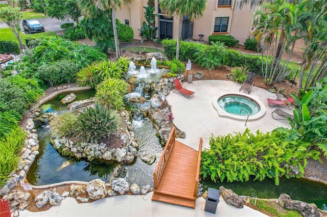 view of swimming pool featuring an in ground hot tub and a patio