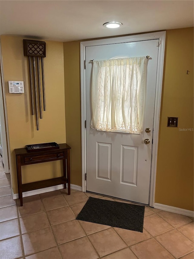 doorway featuring light tile patterned flooring