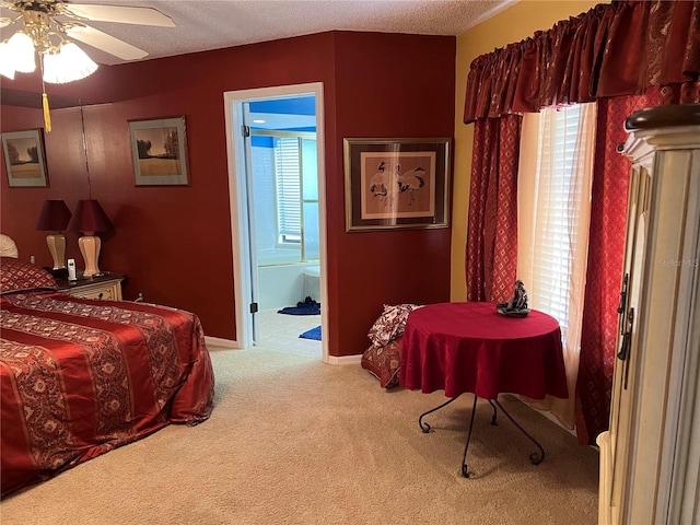 bedroom featuring ceiling fan, carpet, multiple windows, and a textured ceiling