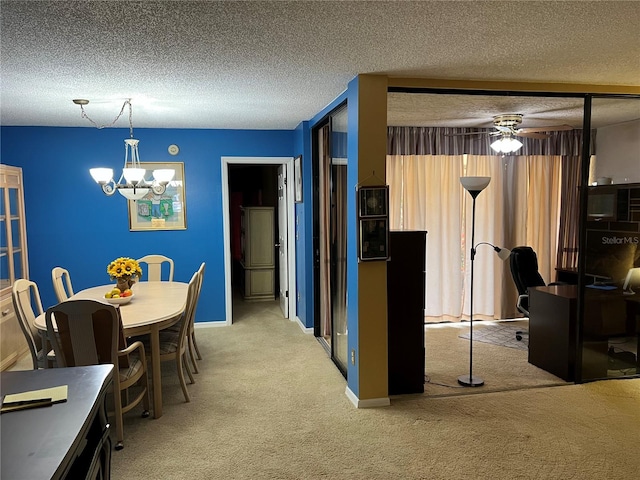 dining space with light colored carpet, a textured ceiling, and ceiling fan with notable chandelier