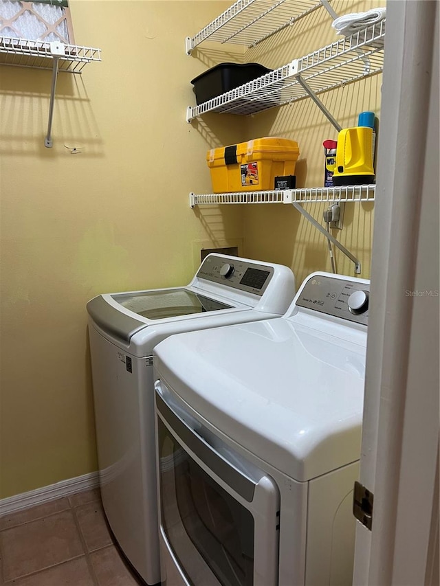 washroom featuring washing machine and clothes dryer and tile patterned floors