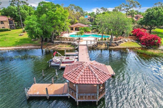 view of dock featuring a lawn and a water view