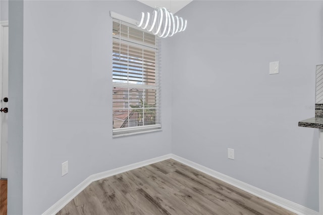 unfurnished dining area featuring hardwood / wood-style floors