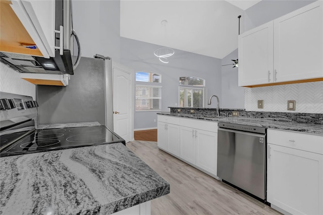 kitchen featuring range, stainless steel dishwasher, light hardwood / wood-style floors, backsplash, and white cabinets