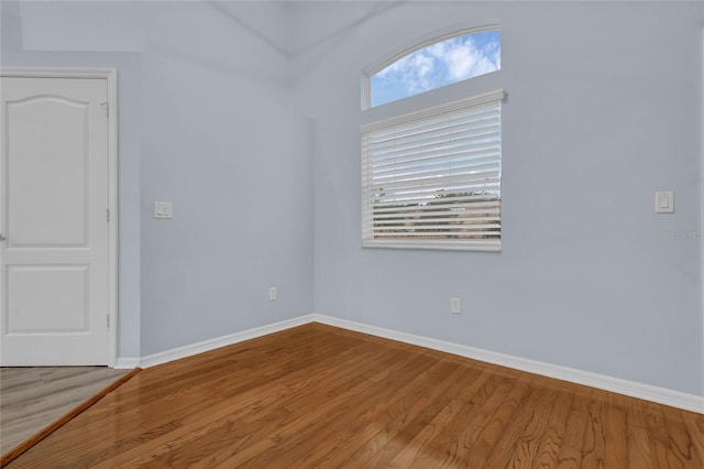 empty room with hardwood / wood-style floors