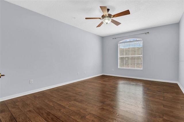 empty room featuring ceiling fan and dark hardwood / wood-style flooring