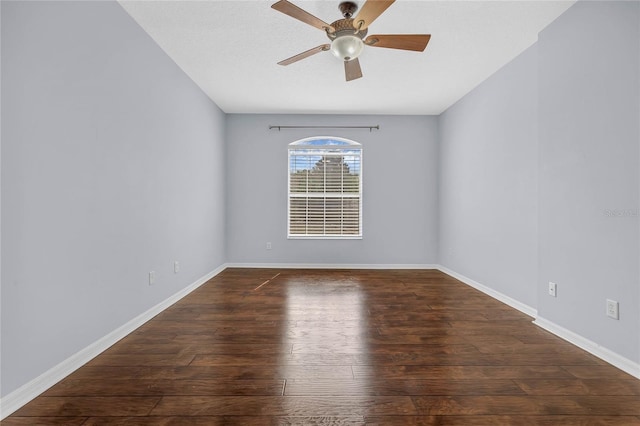 unfurnished room with dark hardwood / wood-style floors and ceiling fan