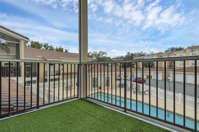 balcony featuring a fenced in pool